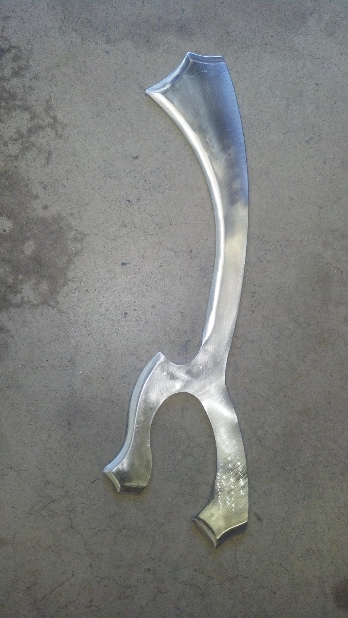 Forged polearm head with curved blade and forked base.