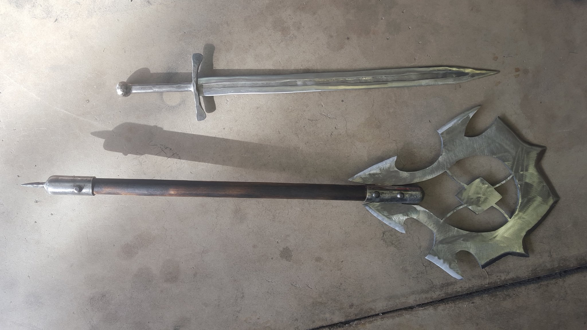 Medieval-style sword paired with an ornate forged war hammer.