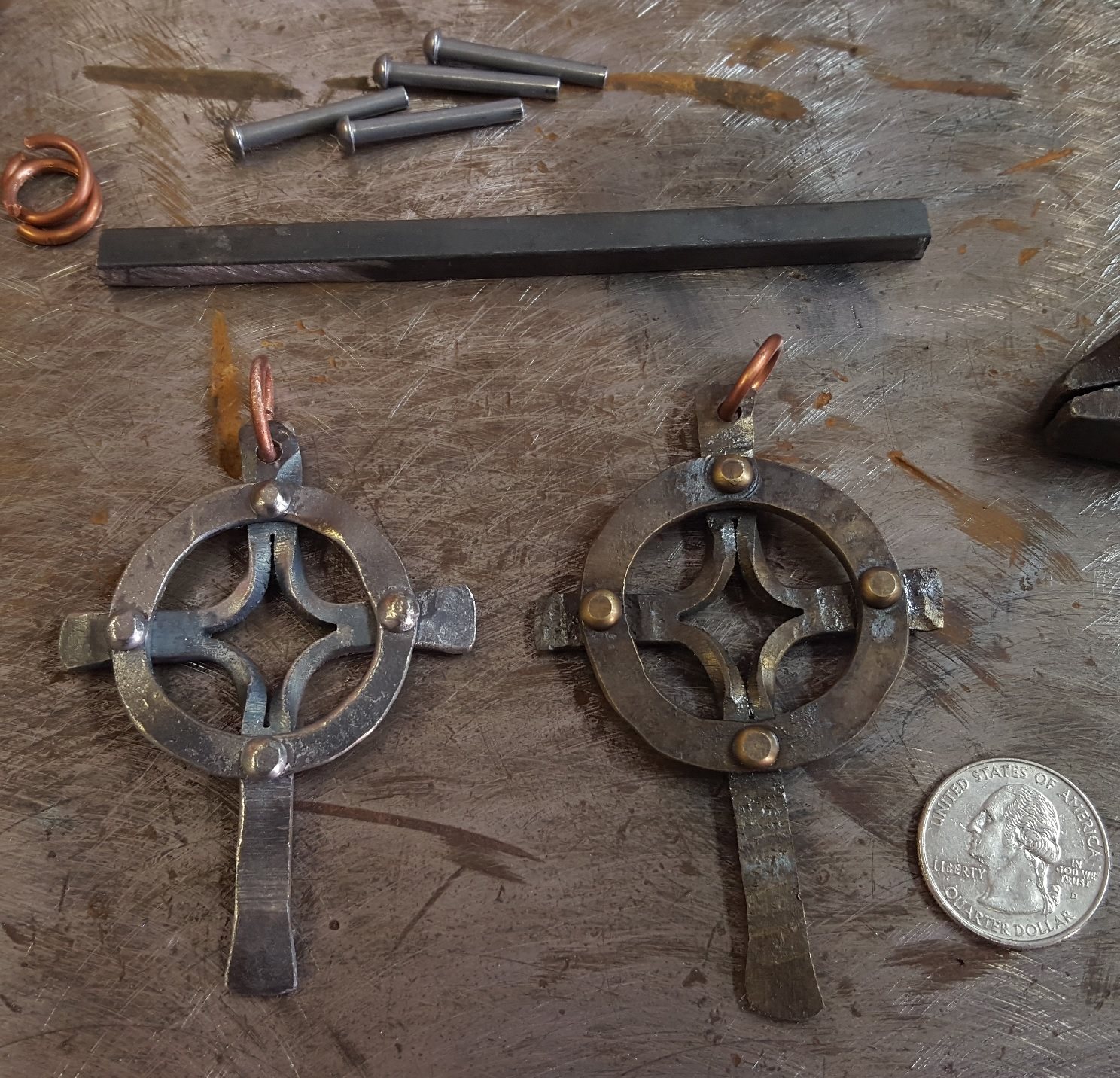Two Celtic cross pendants with brass rivets and copper bails.