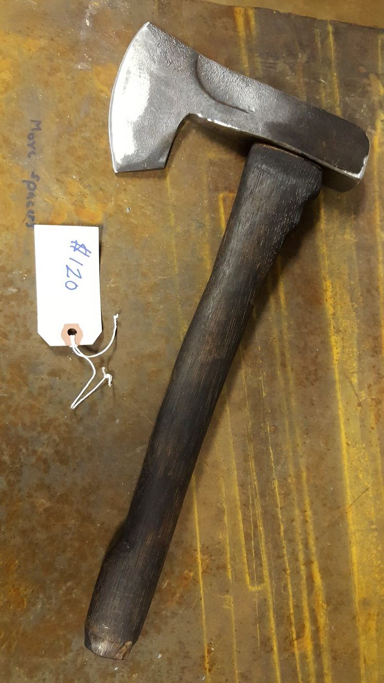Hand-forged hatchet head fitted to a dark hickory handle.