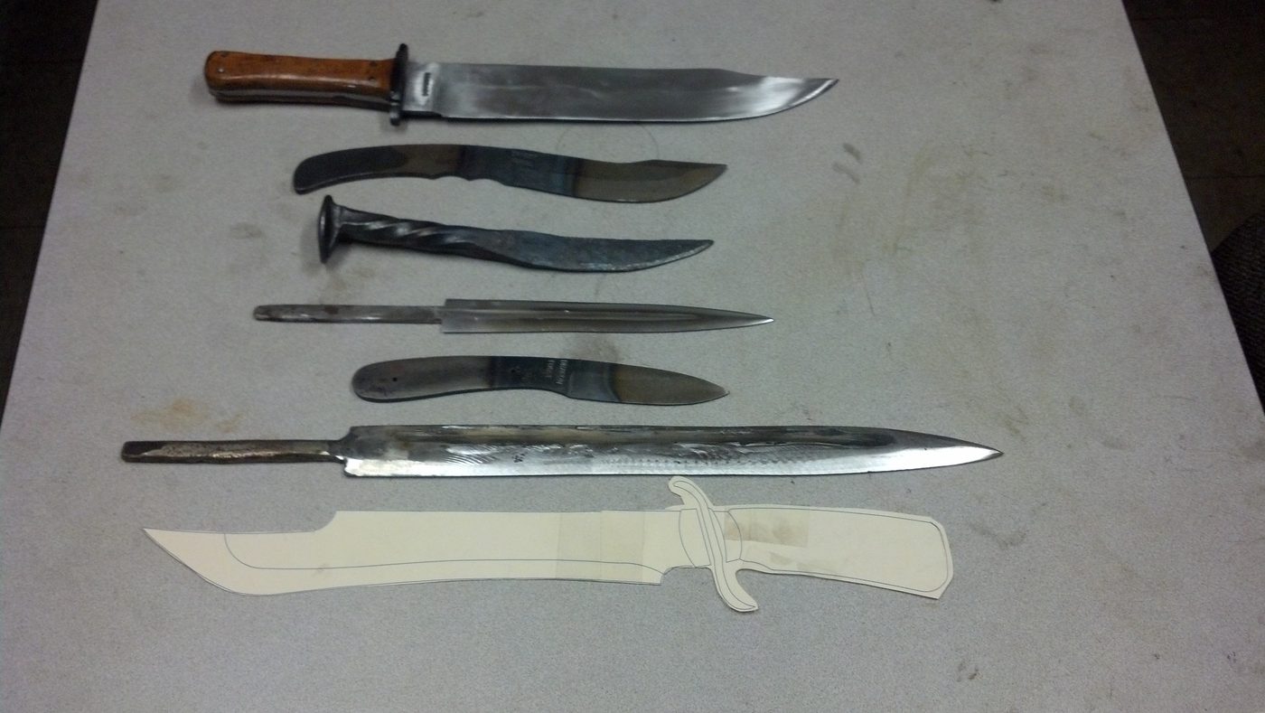 Selection of hand-forged blades in progress on the shop bench.