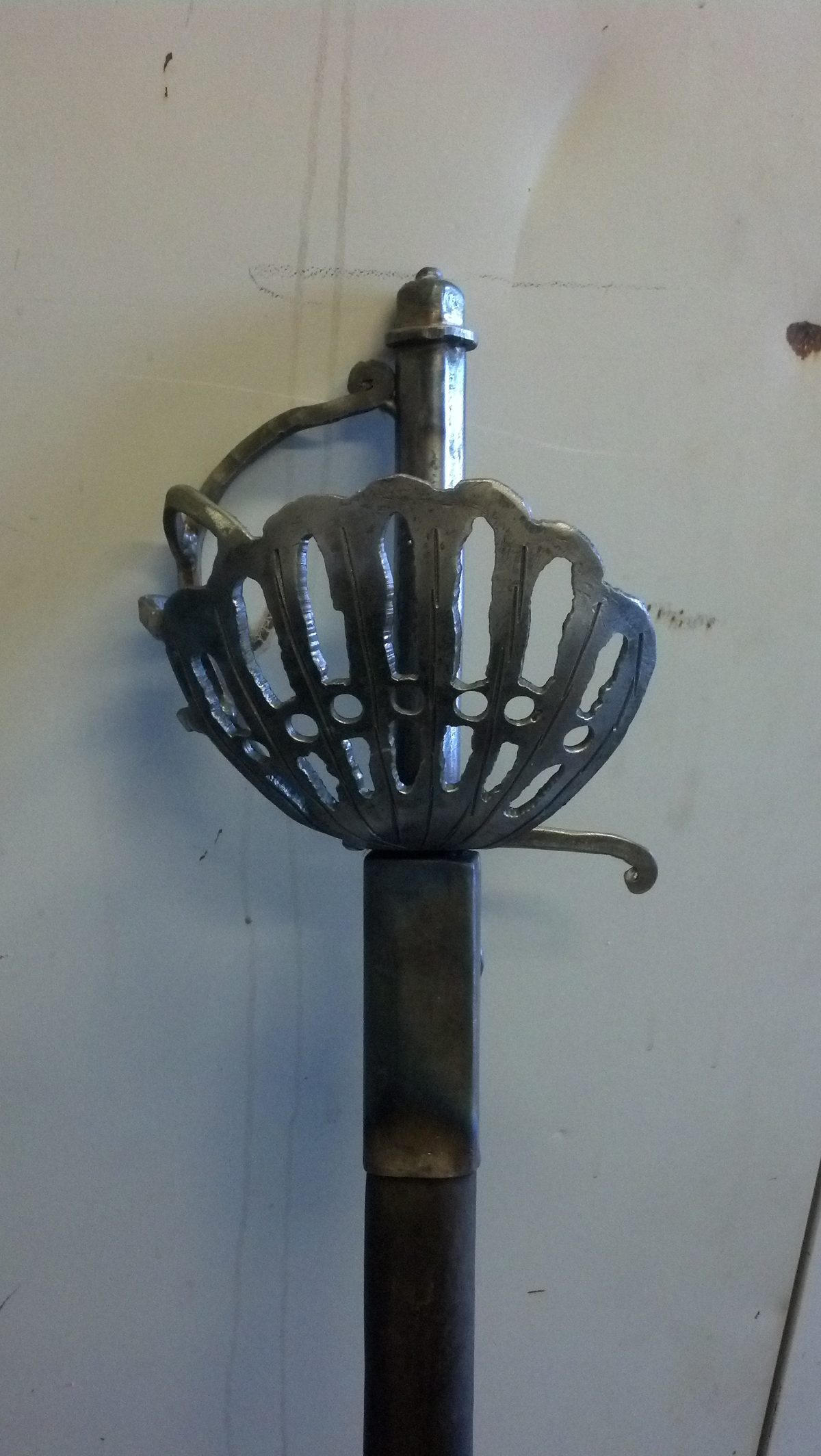 Hand-forged cup-hilt rapier with a pierced steel guard.