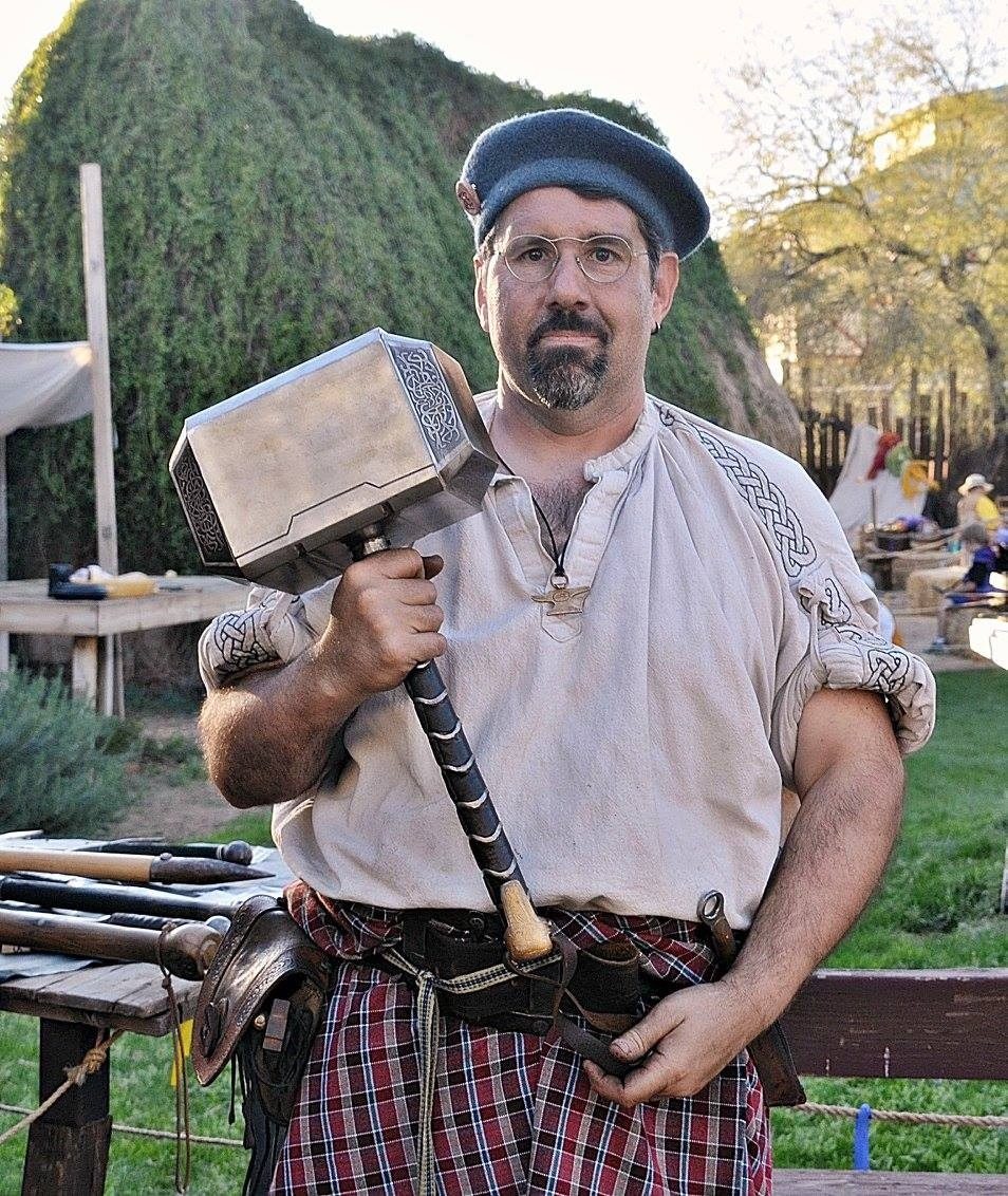 Michael at the Arizona Renaissance Festival holding a finished Mjolnir.